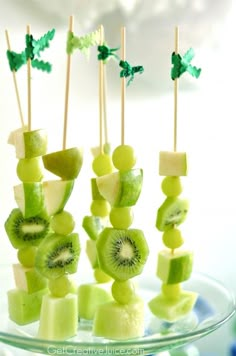 fruit skewers with kiwi slices and leaves on them