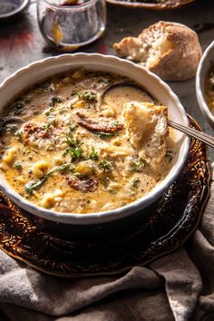 a bowl of soup with bread on the side