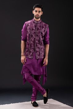 Purple sleeveless bundi with all over foliage embroidery. Paired with long sleeves asymmetric hem kurta and matching churidar.
Components: 3
Pattern: Embroidered
Type Of Work: Foliage
Neckline: Mandarin Collar
Sleeve Type: Bundi: Sleeveless, Kurta: Long
Fabric: Mal Cotton, Raw Silk, Cotton Lycra
Color: Purple
Other Details: 
Approx weight: 2kgs
Poly lining
Occasion: Mehendi and Puja, Sangeet - Aza Fashions Fitted Sleeveless Vest With Zari Work, Designer Sleeveless Kurta For Transitional Season, Sleeveless Embroidered Vest For Festive Occasions, Festive Vest With Intricate Embroidery, Festive Sleeveless Vest With Intricate Embroidery, Sleeveless Kurta With Intricate Embroidery For Eid, Festive Resham Embroidered Sleeveless Vest, Festive Sleeveless Vest With Resham Embroidery, Designer Sleeveless Kurta With Intricate Embroidery