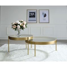 two tables with flowers in vases on top of white carpeted floor next to wall