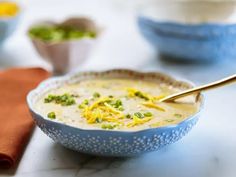 a blue bowl filled with soup on top of a table