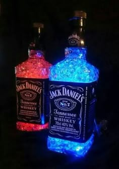 two bottles of jack daniels whiskey glowing in the dark