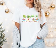 Get ready to be OBSESSED with your new Mele Kalikimaka shirt. It's the cutest and most trendy way to emit all those important Hawaiian Christmas vibes! This is the perfect jolly tshirt! Great as a cute gift! * Q U I C K * F A C T S * ✺ 100% preshrunk cotton ✺ Wash and dry normally (on cool for best results) * S I Z I N G * ✺ Sizing is unisex so runs like men's, though not overly large ✺ Most women find their typical size works best, since they are meant to fit a touch loose. Size up for an oversized fit. ✺ Size guide and fit:  Small - Length 16.5" - Width 27" Medium - Length 18" - Width 28" Large - Length 20" - Width 29" X Large - Length 22" - Width 30" 2x Large - Length 24" - Width 31" * S H I P P I N G * T I M E S * ✺ Our items are individually made with love for each of our buyers. Beca Hawaii Tshirt, Palm Tree Shirt, Christmas Palm Tree, Hawaiian Christmas, Mele Kalikimaka, Tree Shirt, Christmas Vibes, Palm Tree, Cute Gifts