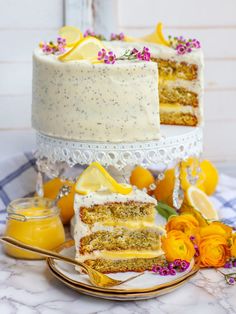 there is a cake with lemons and flowers on the table