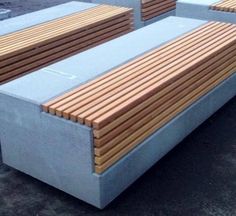 two benches made out of concrete and wooden slats