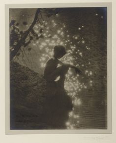 an old photo of a woman standing in the water