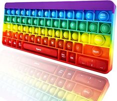 a rainbow colored keyboard sitting on top of a white surface