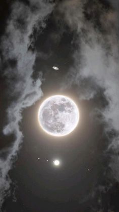 an image of the moon and two planets in the sky with clouds around it at night