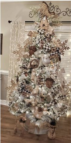 a white christmas tree with brown and black decorations