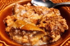 a close up of a plate of food on a table with a fork and spoon