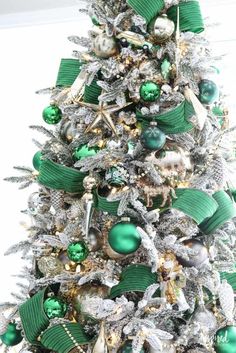 a christmas tree with green and silver ornaments