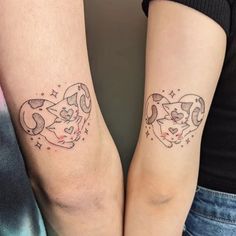 two people with matching tattoos on their arms, one has a cat and the other has a dog