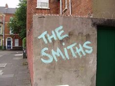 graffiti on the side of a building that says the smiths in blue spray paint