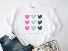 We love our preschoolers! This preschool teacher sweatshirt would be such a nice teacher gift or just a great addition to make teaching and learning more fun! This 4k teacher sweatshirt comes in 3 colors and multiple sizes. Check out more details below! Item Details: Ideal for any situation, a unisex heavy blend crewneck sweatshirt is pure comfort. These garments are made from polyester and cotton. This combination helps designs come out looking fresh and beautiful. The collar is ribbed knit, so it retains its shape even after washing. There are no itchy side seams on these sweaters.  - 50% cotton, 50% polyester - Medium-heavy fabric (8.0 oz/yd² (271.25 g/m - Loose fit - Sewn-in label - Runs true to size Care Instructions: - Machine wash: warm (max 40C or 105F); Non-chlorine: bleach as nee Tk Teacher, Prek Teacher Shirts, Prek Teacher, Teacher Sweatshirt, Teaching And Learning, Preschool Teacher, Teacher Shirts, Teacher Gift, Sew-in Labels