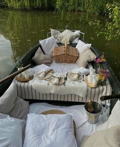 a boat filled with lots of pillows and food on it's back end in the water