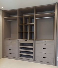 an empty closet with many drawers and shelves