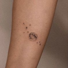 a woman's arm with stars and the moon on it