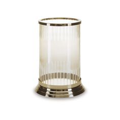 a clear glass vase sitting on top of a white table next to a metal holder