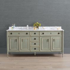 a double sink vanity with marble top and two mirrors on the wall in a bathroom