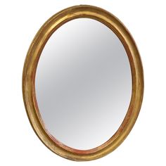 a round mirror is shown against a white background and has gold trimming on the edge