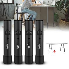 three black plastic cylinders with white stickers on them and a woman sitting at a table in the background