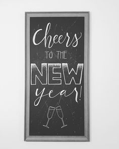 a chalkboard sign that says cheers to the new year