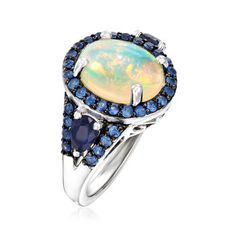 Ross-Simons - Opal and 1.30 ct. t. w. Sapphire Ring in Sterling Silver. Size 10. With a glow that can be seen from across the room, this ring will mesmerize with a gorgeous 12x10mm oval opal cabochon. A halo of .70 ct. t. w. round sapphires in black rhodium and .60 ct. t. w. pear-shaped sapphires add a striking contrast. Set in polished sterling silver. 5/8" wide. Sapphire and opal ring. Opal birthstones are the perfect gift for October birthdays. Opal And Sapphire Ring, October Birthdays, Vintage Sapphire Ring, Moissanite Wedding Ring Set, Opal Birthstone, Ring Opal, Round Sapphire, Classic Engagement Rings, Moissanite Wedding Rings