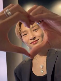 a woman making a heart with her hands