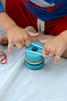 a young boy is playing with a toy