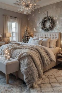 a bedroom decorated for christmas with white furniture and silver decorations on the wall, candles lit up in front of the bed