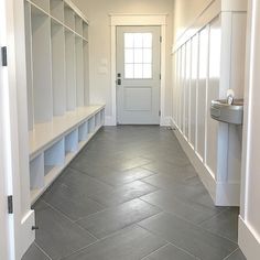 an empty hallway with white cabinets and gray flooring is shown on the instagram page