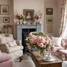 a living room filled with furniture and flowers on top of a coffee table in front of a fire place