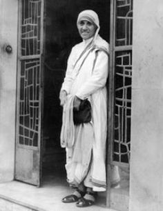 an old photo of a man standing in front of a door