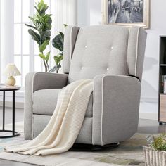 a living room with a gray reclining chair and a white blanket draped over it