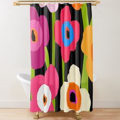 a shower curtain with colorful flowers on black and pink background, in front of a white bath tub