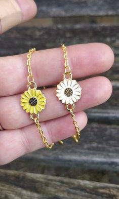 "This bracelet is perfect for anyone! You can choose a yellow sunflower or a white daisy. The metal is a gold color. The flower measures 1/2\" wide. The bracelet has an extender on it so it is adjustable, and it has a heart charm at the end. Perfect for a Mom gift, for a Christmas gift, anniversary, or a birthday. All jewelry items come in a gift box." Personalized Flower Jewelry For Friendship, Personalized Flower-shaped Jewelry For Friendship, Personalized Flower Shaped Friendship Jewelry, Cute Gold Jewelry With Flower Charm, Personalized Flower-shaped Friendship Jewelry, White Flower Charm Jewelry For Friendship, White Jewelry With Flower Charm For Friendship, Gold Bracelets With Flower Shape For Mother's Day, Gold Flower-shaped Bracelets For Mother's Day