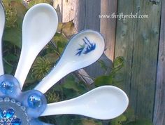 three spoons in the shape of a flower are sitting on top of each other