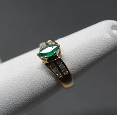 7 x 3.75mm marquis Emerald in great color. 12 Diamonds in an off set shoulder design. A really elegant ring showing light wear. 1.66 dwt. Update: Per customer request, Had Karin take a look at the stone. Excellent stone with a tiny chip on the girdle. Through a 10X loupe to find it. Adjusting price accordingly Marquise Emerald Ring With Center Stone, Marquise Emerald Ring For Formal Occasions, 14k Gold Marquise Cut Emerald Ring, Marquise Cut Emerald Promise Ring, Classic Emerald Ring Marquise Cut, Classic Marquise Cut Emerald Promise Ring, Classic Marquise Cut Emerald Ring, Emerald Diamond Ring, Diamond Engagement Rings Vintage