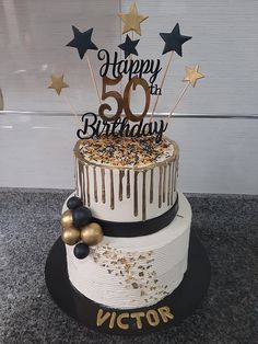 a 50th birthday cake decorated with gold stars