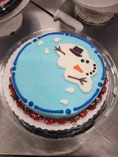 there is a frosted cake with a snowman on it