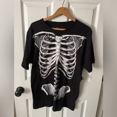 Get Into The Halloween Spirit With This Men's Short Sleeve Black Skeleton Tee Shirt From Celebrate Halloween. The Shirt Features A Crew Neckline And A Regular Fit, Perfect For Any Halloween Celebration. Made Of A Blend Of Polyester And Cotton, This Shirt Is Machine Washable For Easy Care. The Black Color Adds A Touch Of Spookiness, While The Skeleton And Halloween Theme Make It A Fun Addition To Your Halloween Wardrobe. This Shirt Is Size Medium And Is Perfect For Men Who Want To Show Off Their 1984 Shirt, Tupac T Shirt, Halloween Tee Shirts, Black Skeleton, Limited Edition Shirt, Bleach Art