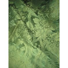 an image of green fabric with flowers on it