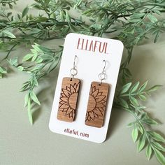 the earrings are made from wood and have sunflowers on them