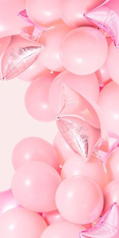 a bunch of pink balloons and some silver shoes