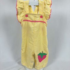 Yellow and white striped seersucker overall jumper with pink details and strawberry appliqué. Two buttons on each strap to adjust shoulder length. Waist is elastic. Snaps up legs for easy changing. Size: Small - 24.5"-28" - 15 to 20 lbs. Looks around 6-9 months. Please see measurements below to ensure fit. Measurements (approximate): Shoulder to Hem: 20" Armpit to Armpit: 9.5" Be sure to check out my shop! New items added often! https://www.etsy.com/shop/AutumnRoseArtVintage Spring Cute Bib Front Overalls, Spring Ruffled Overalls, Spring Ruffle Overalls, Casual Ruffled Overalls For Spring, Cute Cotton Bib Front Overalls, Cute Bib Front Overalls For Summer, Casual Ruffled Overalls For Summer, Spring Pink Bib Front Overalls, Cute White Overalls For Spring