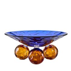 three glass balls in a bowl on a white background