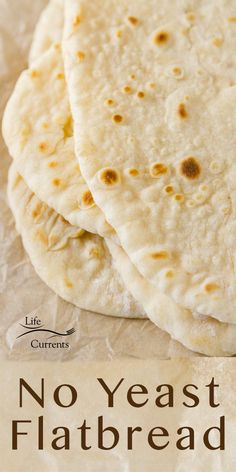 three flatbreads sitting on top of a piece of paper with the words, no yeast flatbread