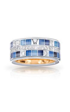 a white and blue ring with diamonds on it's sides, set in 18k gold