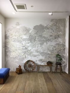 an old brick wall in a room with wooden floors