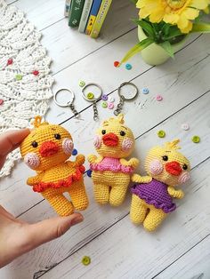 three crocheted stuffed animals sitting next to each other on top of a table